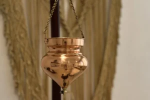 Shirodhara vessel to gently drip warm oil, milk, or herbal liquids in a steady stream onto the forehead