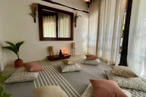 Private meditation room with comfortable cushions, a Buddha, incense and air conditioning.