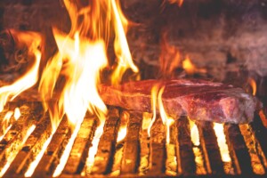 a Prime cut cooking on the wood fired grill